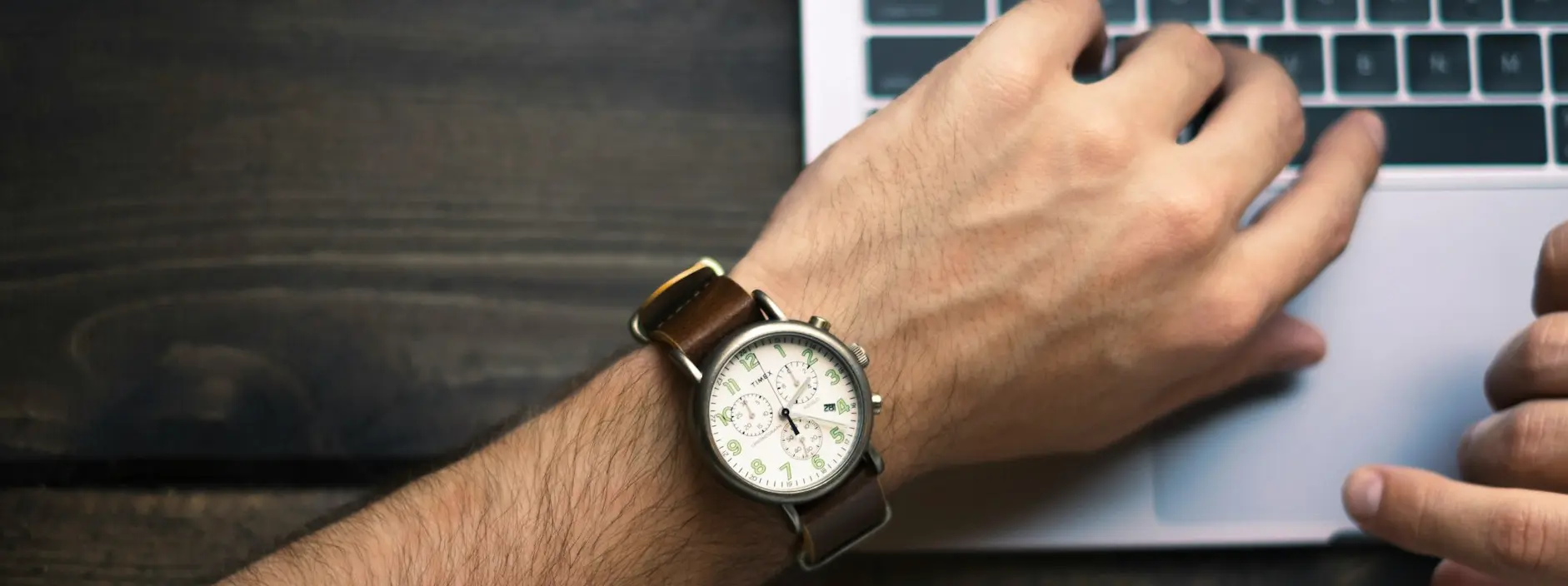 person wearing brown and white watch